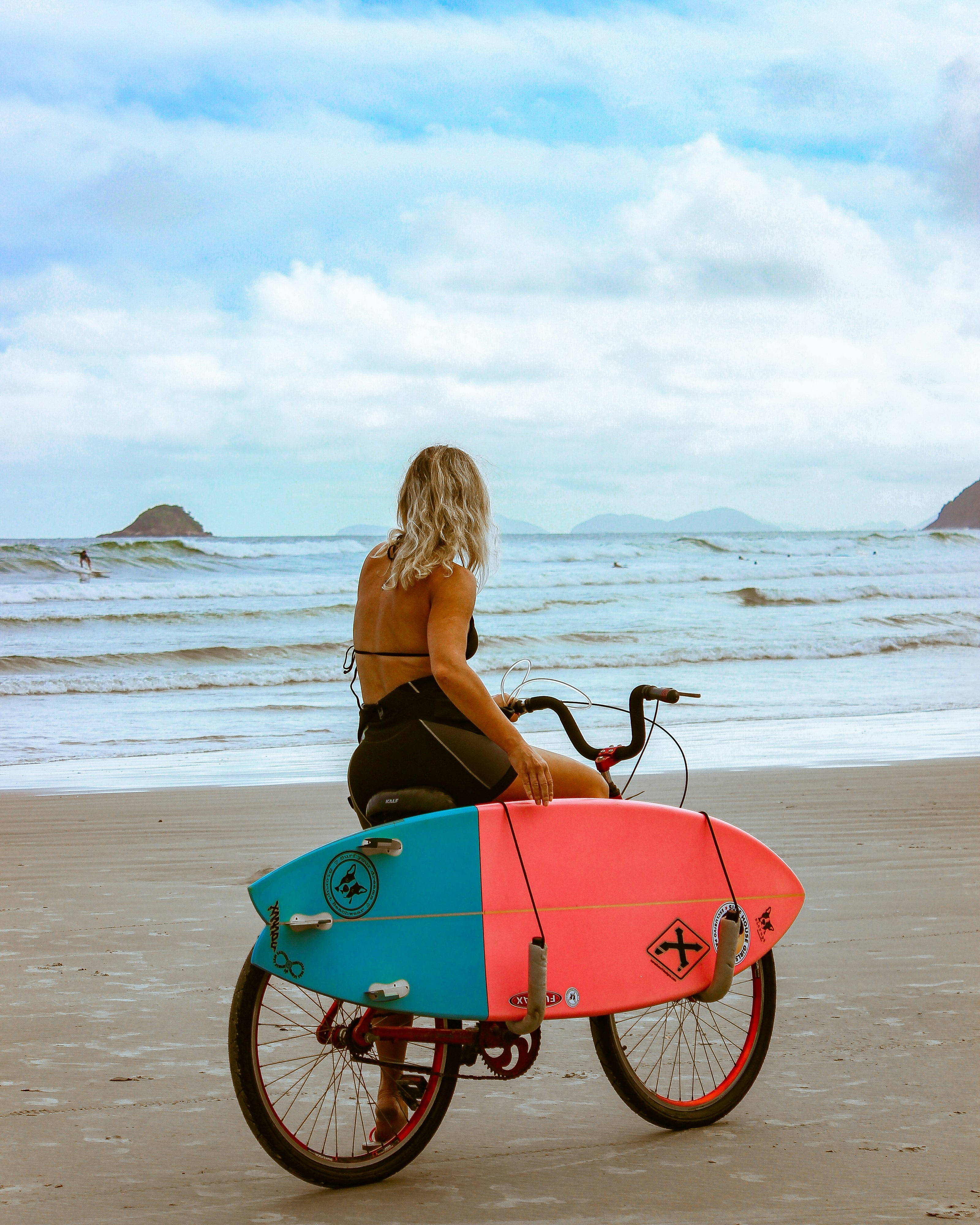 Surfer on bike with surf board